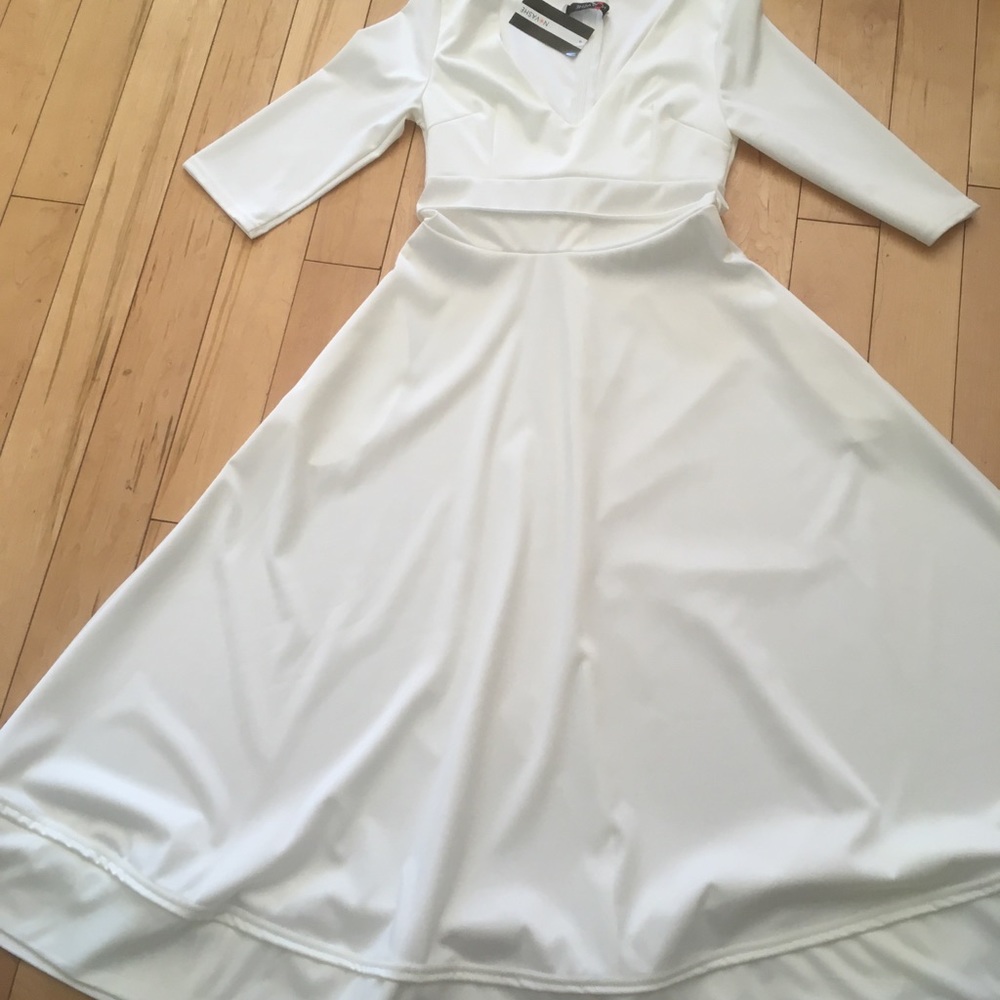 White fit and flair dress with three-quarter length sleeves. Size medium